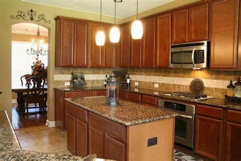 Uba tuba granite countertops is a versatile granite that can complement kitchen cabinets of many different colors and designs. new-venetian-gold-granite-with-honey-oak-cabinets-gallery ...