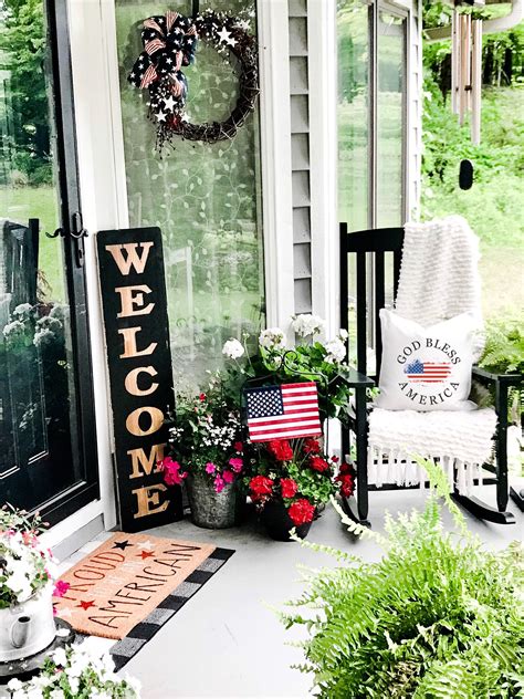 A Porch Decorated For The Fourth Of July With Flowers And Welcome Home