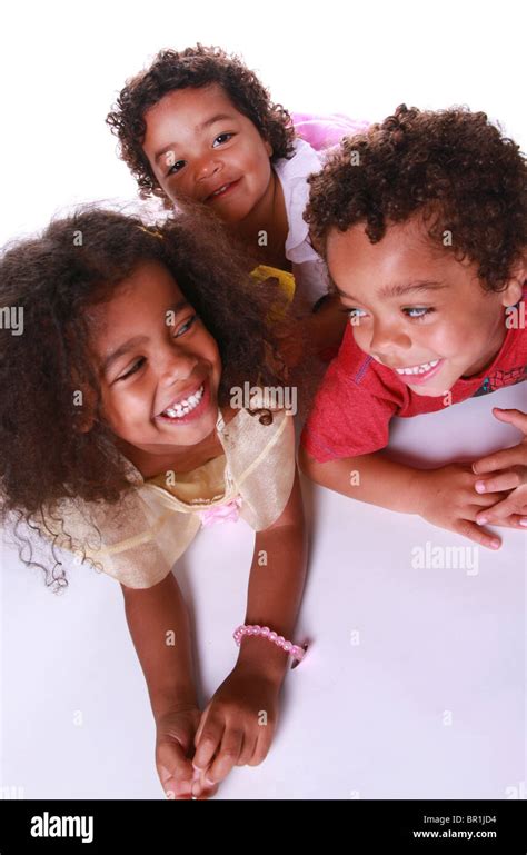 Siblings Lying On Floor Laughing Stock Photo Alamy