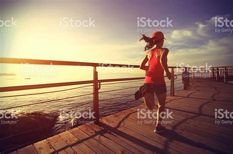 Young Fitness Woman Legs Running On Seaside Wooden Boardwalk Fitness
