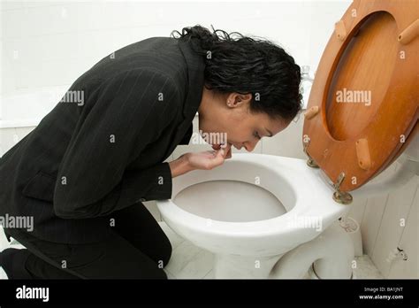 Woman Vomiting Into Toilet Stock Photos And Woman Vomiting Into Toilet