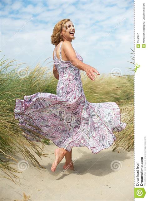 Woman With Flowing Dress At The Beach Royalty Free Stock