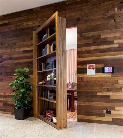 An Open Book Case In The Middle Of A Room With Wood Paneling On The Walls