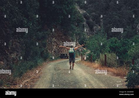 Senior Man In The Middle Of The Road In The Forrest Image Of A Hiker From The Back In The