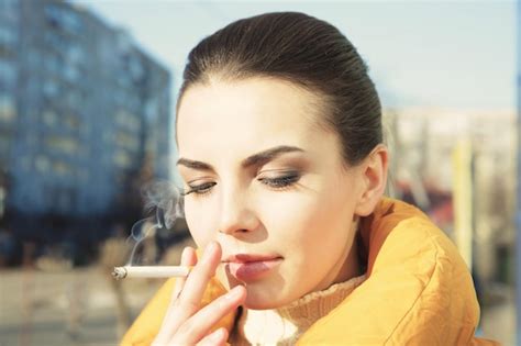 Premium Photo Young Woman Smoking Cigarette Outdoor