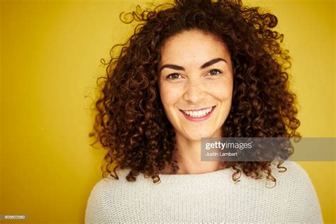 Curly Haired Mixed Race Woman Smiling Openly At Camera On Vibrant
