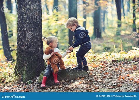 Little Boy And Girl Friends Camping In Woods Children Play In Autumn