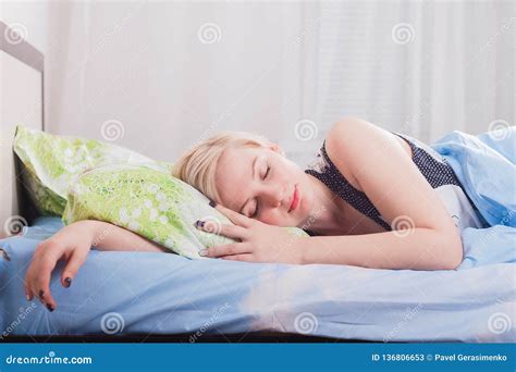 Young Beautiful Blonde Woman Sleeping In Her Bed In The Morning Stock