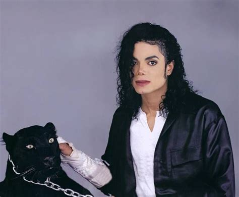 Michael Jackson Posing With A Black Cat In His Hand And Chain Around