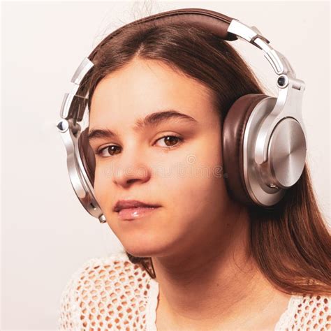Portrait Of A Young Woman Wearing Headphones Relaxing At Home Stock
