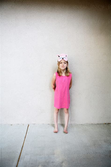 Tiny Girl With Mask On Forehead In Pink Dress By Stocksy Contributor Dina Marie Giangregorio