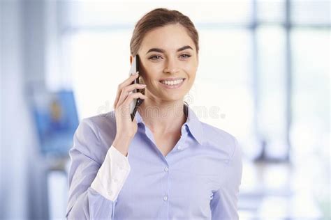 Portrait Of Young Businesswoman Making A Phone Call On Her Cell Phone