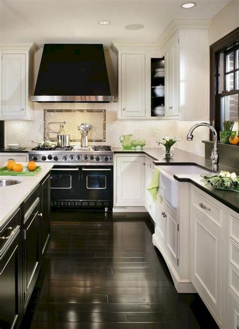 Ivory kitchen cabinet with black island, marble countertop and oak wood flooring. White Cabinets With Black Countertops: 12 Inspiring ...