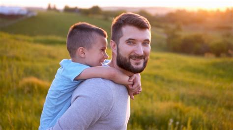 Happy Father And Son Enjoying Sunset In Field Stock Video Footage 0029