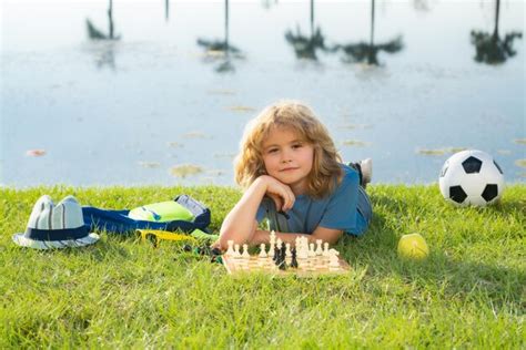 Premium Photo Little Kid Play Chess In Park Child Boy Playing Board