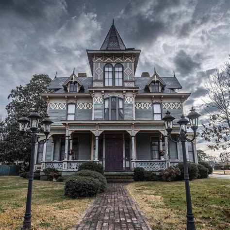 An Old Victorian Style House On A Cloudy Day