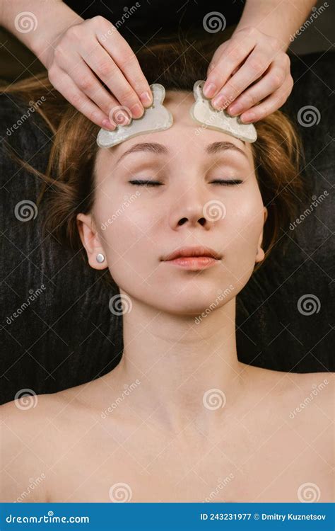 Pleased Woman Receiving Forehead Massage In A Beauty Salon Stock Image Image Of Guasha