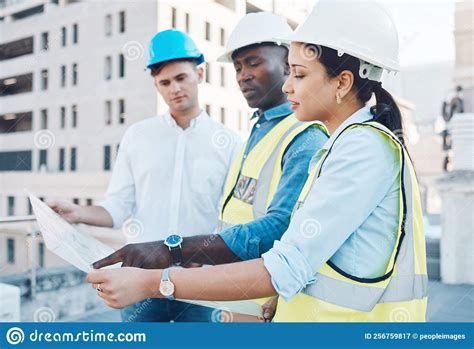 Engineer Architect And Planning With Blueprint On A Construction Site