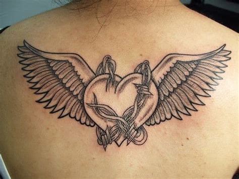 A Womans Back With A Heart And Wings Tattoo