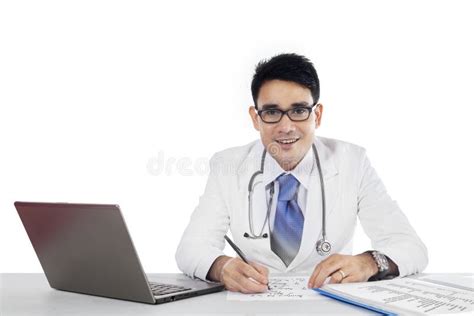 Doctor Writes A Prescription And Looking At Camera Stock Photo Image