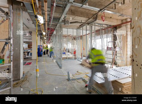 Construction Workers Working On Interior Of A Building Stock Photo Alamy