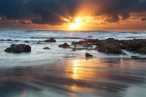 Sunrise Landscape Of Ocean With Waves Clouds And Rocks