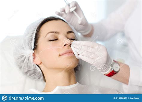 Attractive Young Woman Is Getting A Rejuvenating Facial Injections She Is Sitting Calmly At