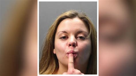 woman sucks on finger in mugshot