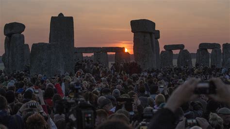 Summer Solstice Revelers Greet The Midsummer Sunrise At Stonehenge