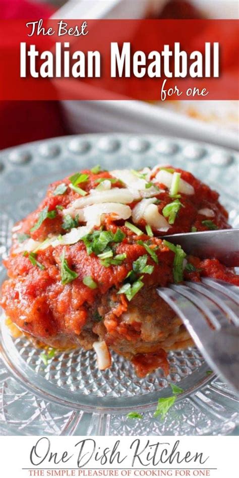 The Best Italian Meatball For One Is On A Plate With A Fork And Knife
