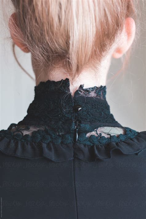 Back View Of Girl With Blonde Hair Wearing A High Collared Black Lace