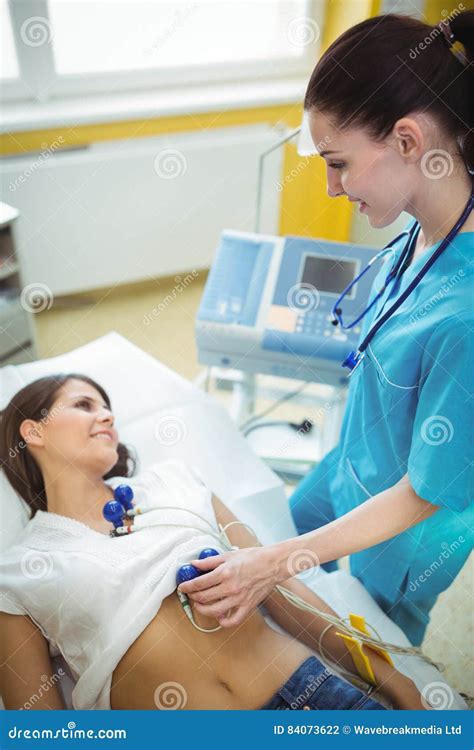 Nurse Performing An Electrocardiogram Test On The Patient Stock Photo