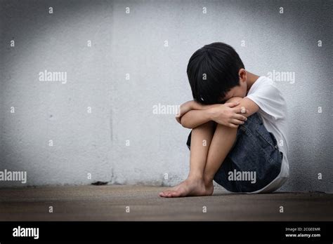 A Boy Sitting Alone With Sad Feeling Asian Little Child Covered His