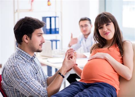 Pregnant Woman With Her Husband Visiting The Doctor In Clinic Stock Image Image Of Care