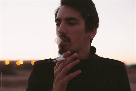 Man Smoking Cigarette By Stocksy Contributor Swell Visuals Stocksy