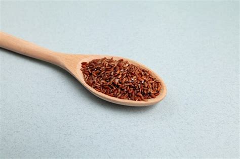 Premium Photo Brown Gaba Rice In Long Wooden Spoon Closeup Selective