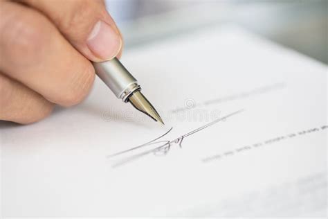 Businessman Is Signing A Contract Focus On Pen Stock Photo Image Of