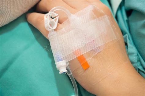 Asian Woman Patient Hand On Iv Drip With Saline Solution Fluid Stock
