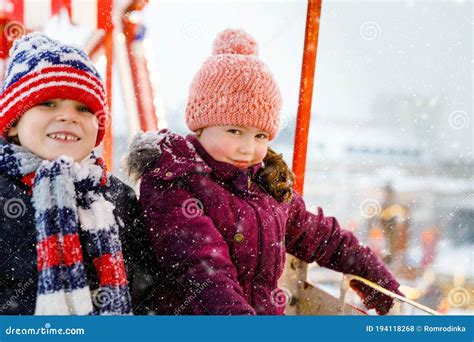 Two Little Kids Boy And Girl Having Fun On Ferris Wheel On Traditional