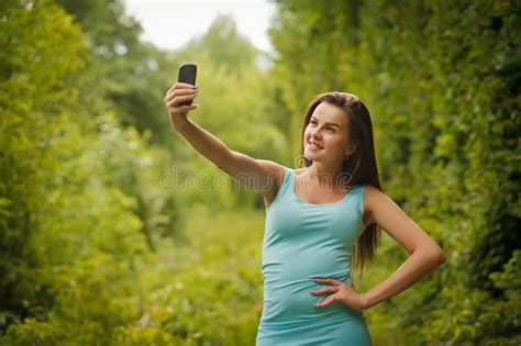 Cute Smiling Young Caucasian Teenage Girl Taking A Selfie Outdoors On Sunny Summer Day Stock