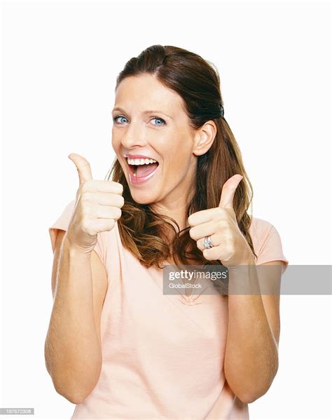 Excited Mid Adult Woman Showing Thumbs Up Sign On White Stock Photo