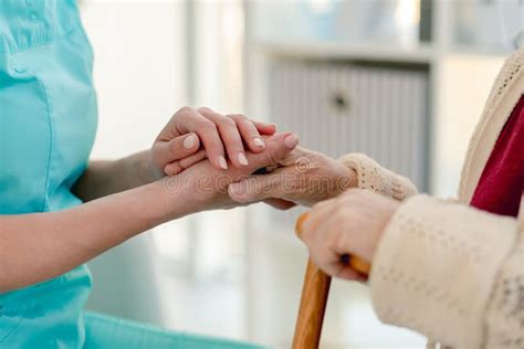 Old Woman In Hands Of Caregiver Stock Photo Image Of Indoors Older