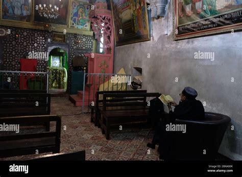 An Ethiopian Orthodox Monk Praying Inside The Small Chapel Dedicated To