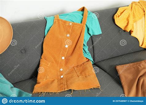 Messy Pile Of Clothes On Sofa In Living Room Stock Image Image Of