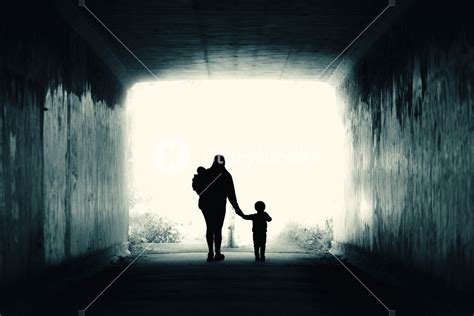 A Single Mother And Two Children Walk Into The Light Royalty Free Stock
