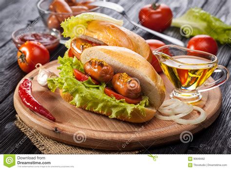 Hot Dog With Tomato Lettuce Sausage Mustard Ketchup Stock Photo