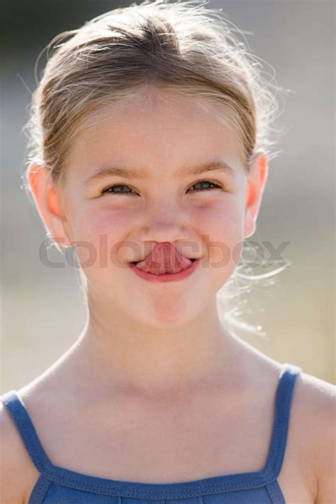 Girl Touching Nose With Tongue Stock Image Colourbox