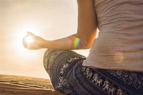 Young Woman Meditating In Rad Sandy Desert At Sunset Stock Image