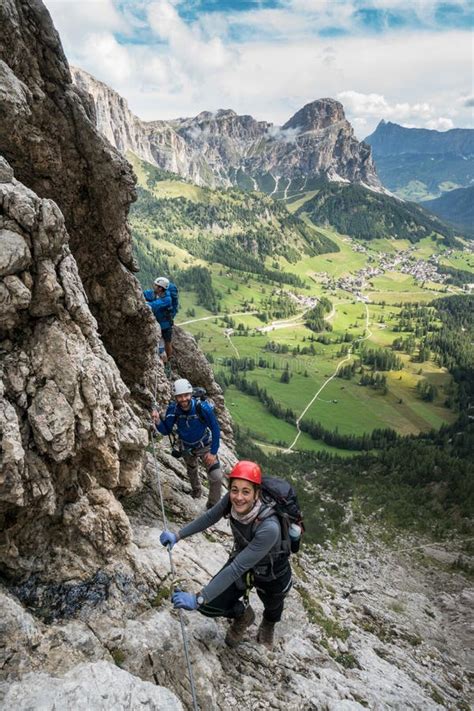 Three Mountain Climbers On A Via Ferrata In The Dolomites In Alta Badia