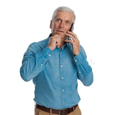 Thoughtful Old Man Talking On The Phone And Thinking Stock Photo